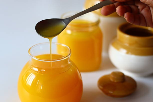 Homemade Cow Ghee. A clarified butter made by slow heating butter until milk solids and water evaporate, creating a golden, clear liquid with a rich aroma and deep flavor. Stored in glass bottles